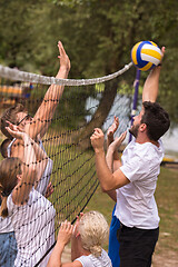 Image showing group of young friends playing Beach volleyball