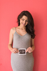 Image showing happy pregnant woman showing ultrasound picture