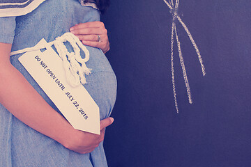 Image showing Portrait of pregnant woman in front of black chalkboard