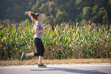 Image showing woman jogging along a country road