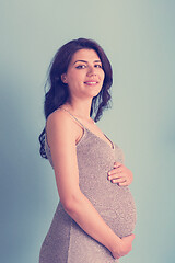 Image showing Portrait of pregnant woman over blue background