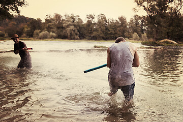 Image showing young men having fun with water guns