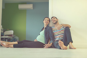 Image showing pregnant couple sitting on the floor