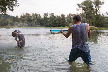 Image showing young men having fun with water guns