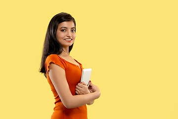 Image showing Portrait of beautiful woman isolated on yellow studio background