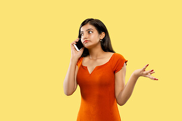 Image showing Portrait of beautiful woman isolated on yellow studio background