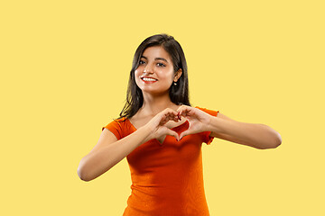 Image showing Portrait of beautiful woman isolated on yellow studio background