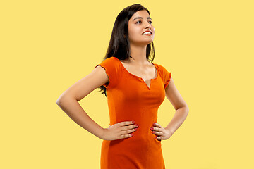 Image showing Portrait of beautiful woman isolated on yellow studio background