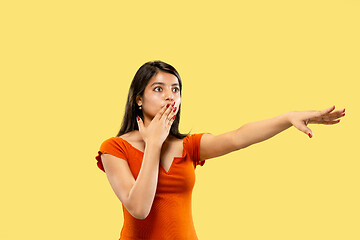 Image showing Portrait of beautiful woman isolated on yellow studio background