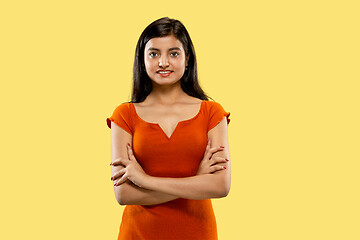 Image showing Portrait of beautiful woman isolated on yellow studio background