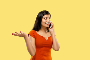 Image showing Portrait of beautiful woman isolated on yellow studio background