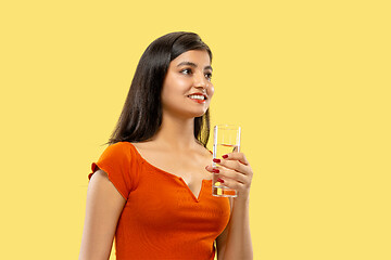 Image showing Portrait of beautiful woman isolated on yellow studio background