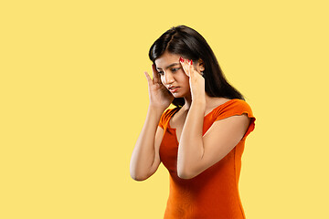 Image showing Portrait of beautiful woman isolated on yellow studio background