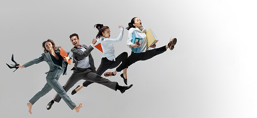 Image showing Office workers jumping isolated on studio background