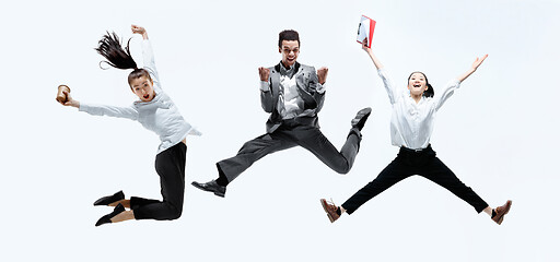 Image showing Office workers jumping isolated on studio background