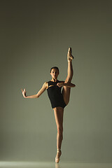 Image showing Young graceful female ballet dancer dancing in mixed light