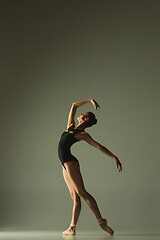 Image showing Young graceful female ballet dancer dancing in mixed light