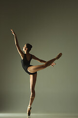 Image showing Young graceful female ballet dancer dancing in mixed light