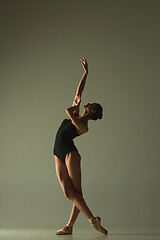 Image showing Young graceful female ballet dancer dancing in mixed light