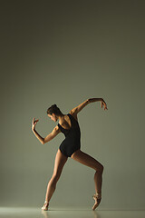 Image showing Young graceful female ballet dancer dancing in mixed light