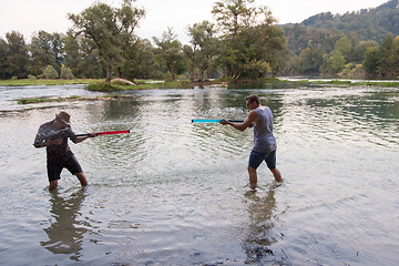 Image showing young men having fun with water guns