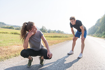 Image showing young couple warming up and stretching on a country road