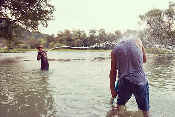 Image showing young men having fun with water guns