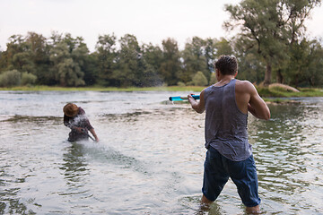 Image showing young men having fun with water guns