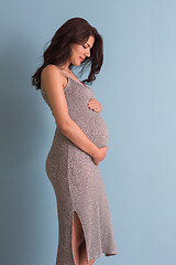 Image showing Portrait of pregnant woman over blue background