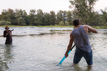 Image showing young men having fun with water guns