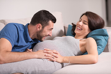 Image showing future dad listening the belly of his pregnant wife