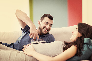 Image showing young pregnant couple relaxing on sofa