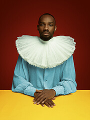 Image showing Young man as a medieval grandee on red background