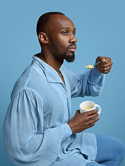 Image showing Young man as a medieval grandee on blue background