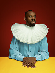 Image showing Young man as a medieval grandee on red background