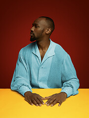 Image showing Young man as a medieval grandee on red background