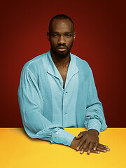 Image showing Young man as a medieval grandee on red background