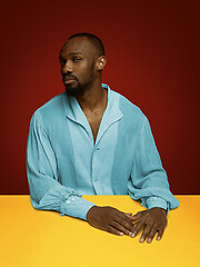 Image showing Young man as a medieval grandee on red background