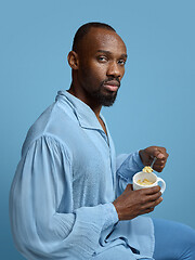 Image showing Young man as a medieval grandee on blue background