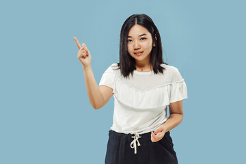 Image showing Korean young woman\'s half-length portrait on blue background