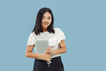 Image showing Korean young woman\'s half-length portrait on blue background