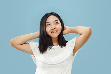 Image showing Korean young woman\'s half-length portrait on blue background