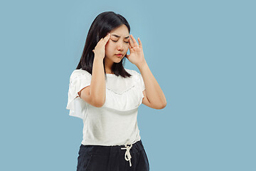 Image showing Korean young woman\'s half-length portrait on blue background