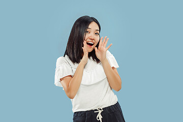 Image showing Korean young woman\'s half-length portrait on blue background