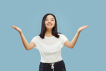 Image showing Korean young woman\'s half-length portrait on blue background