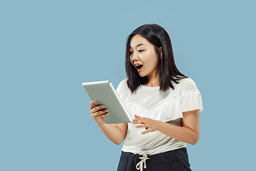 Image showing Korean young woman\'s half-length portrait on blue background