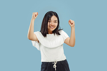 Image showing Korean young woman\'s half-length portrait on blue background