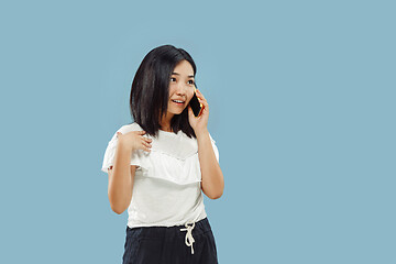 Image showing Korean young woman\'s half-length portrait on blue background