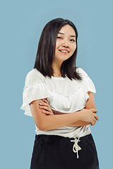 Image showing Korean young woman\'s half-length portrait on blue background