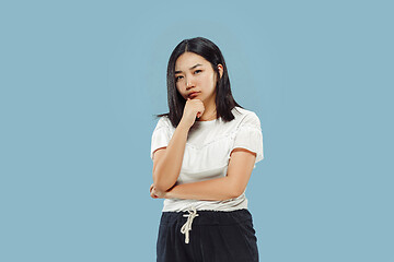 Image showing Korean young woman\'s half-length portrait on blue background